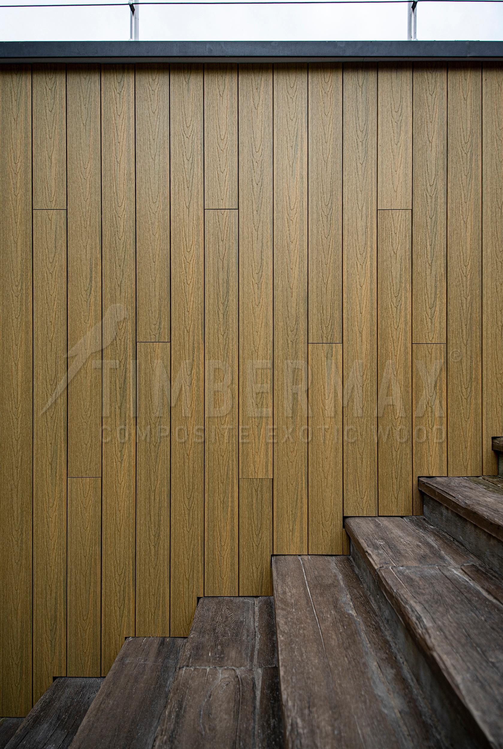 facade cladding natural wood look from composite boards on the modern facade of the house