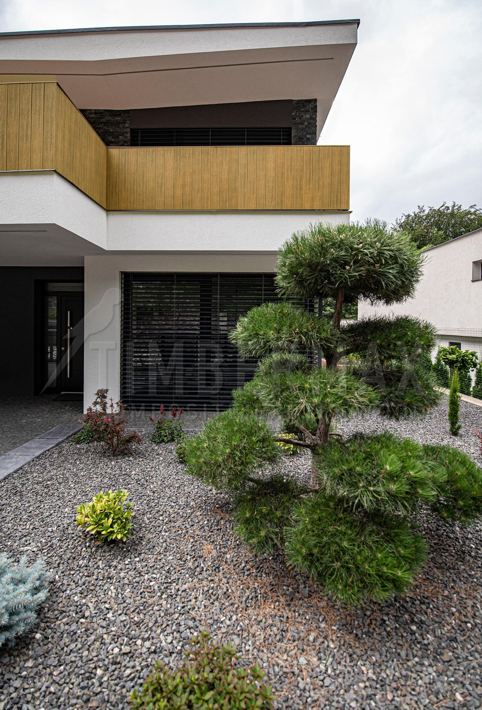modern family house with facade cladding natural wood look from composite boards for the facade