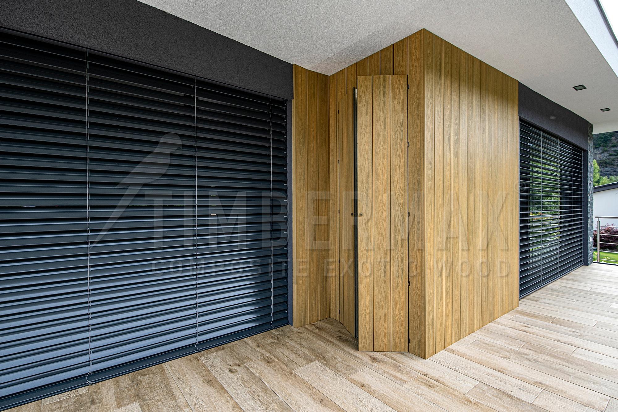 modern overhanging facade with light wood-imitation facade cladding