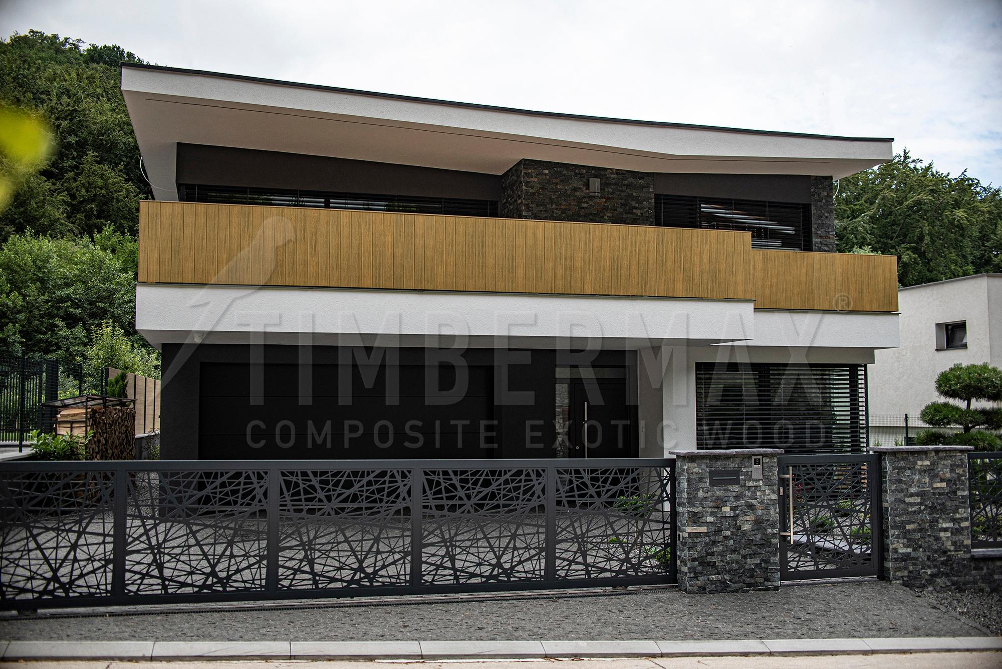 a modern family house with a projecting facade and imitation wood facade cladding