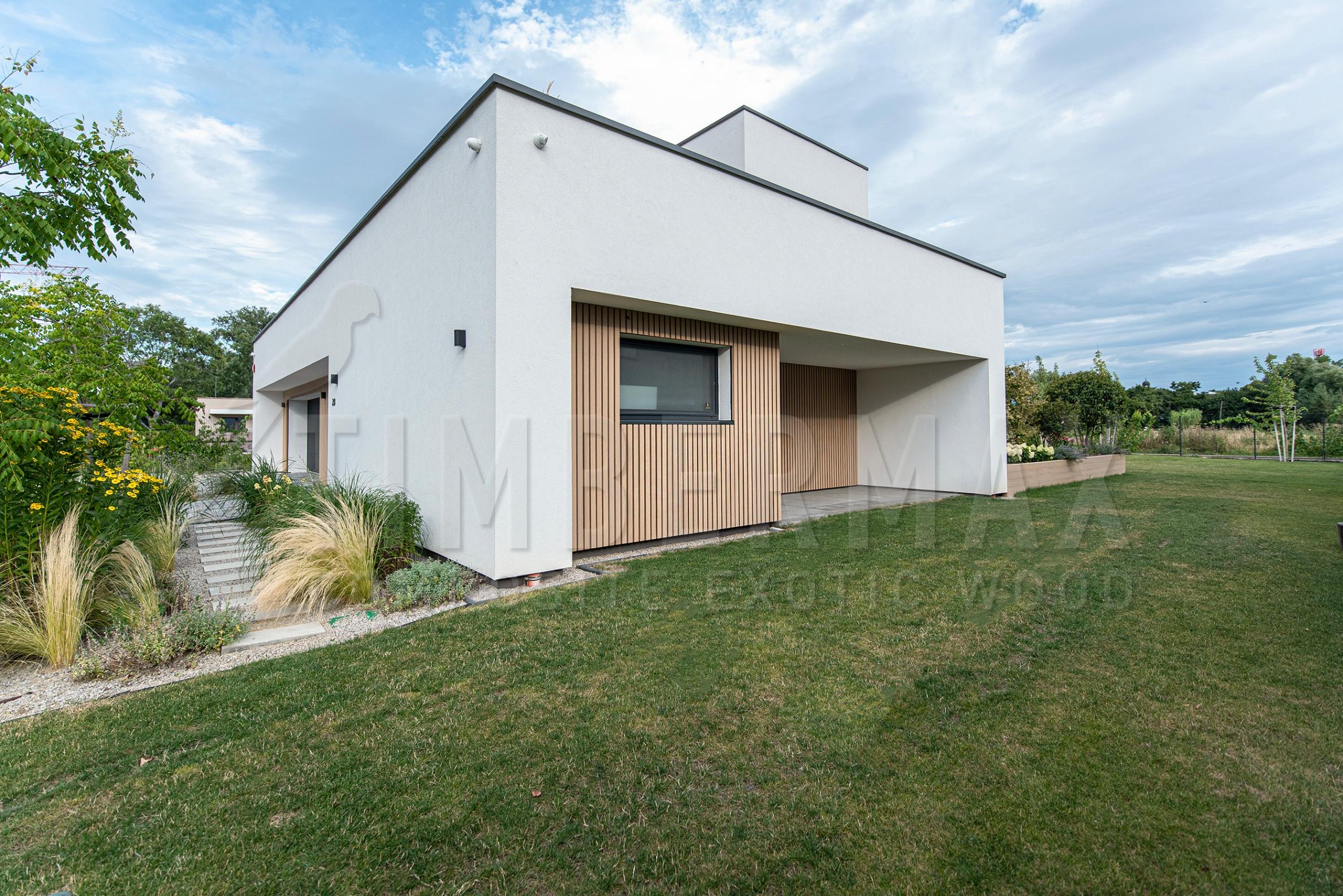 a modern house with a slatted facade made of composite boards
