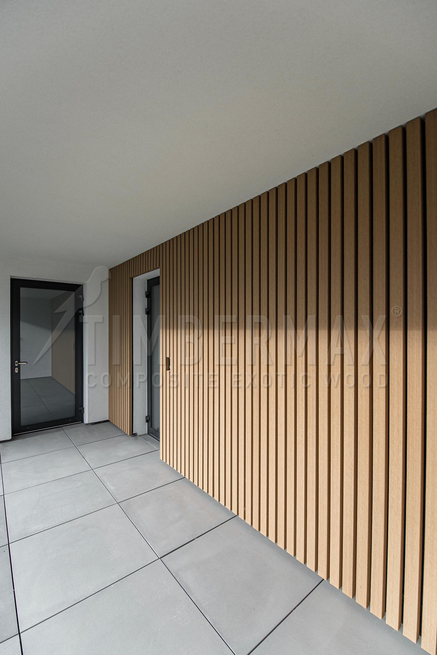 vertical sunscreens made of composite boards on the facade of a modern house