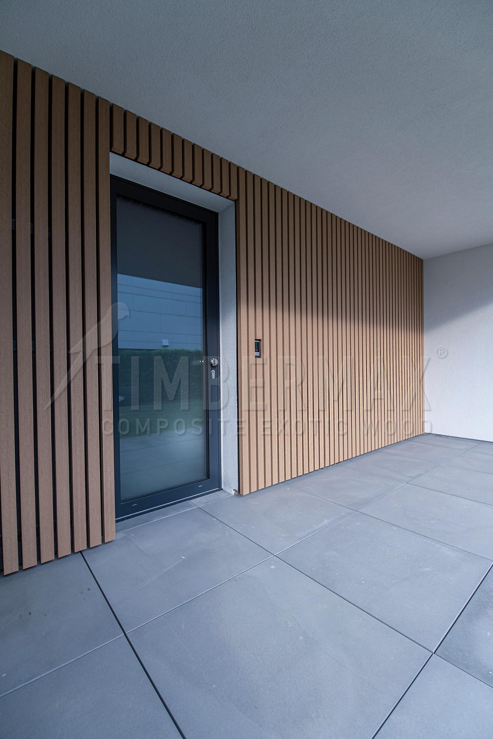 detail of the facade of the house with vertical solar panels made of composite boards