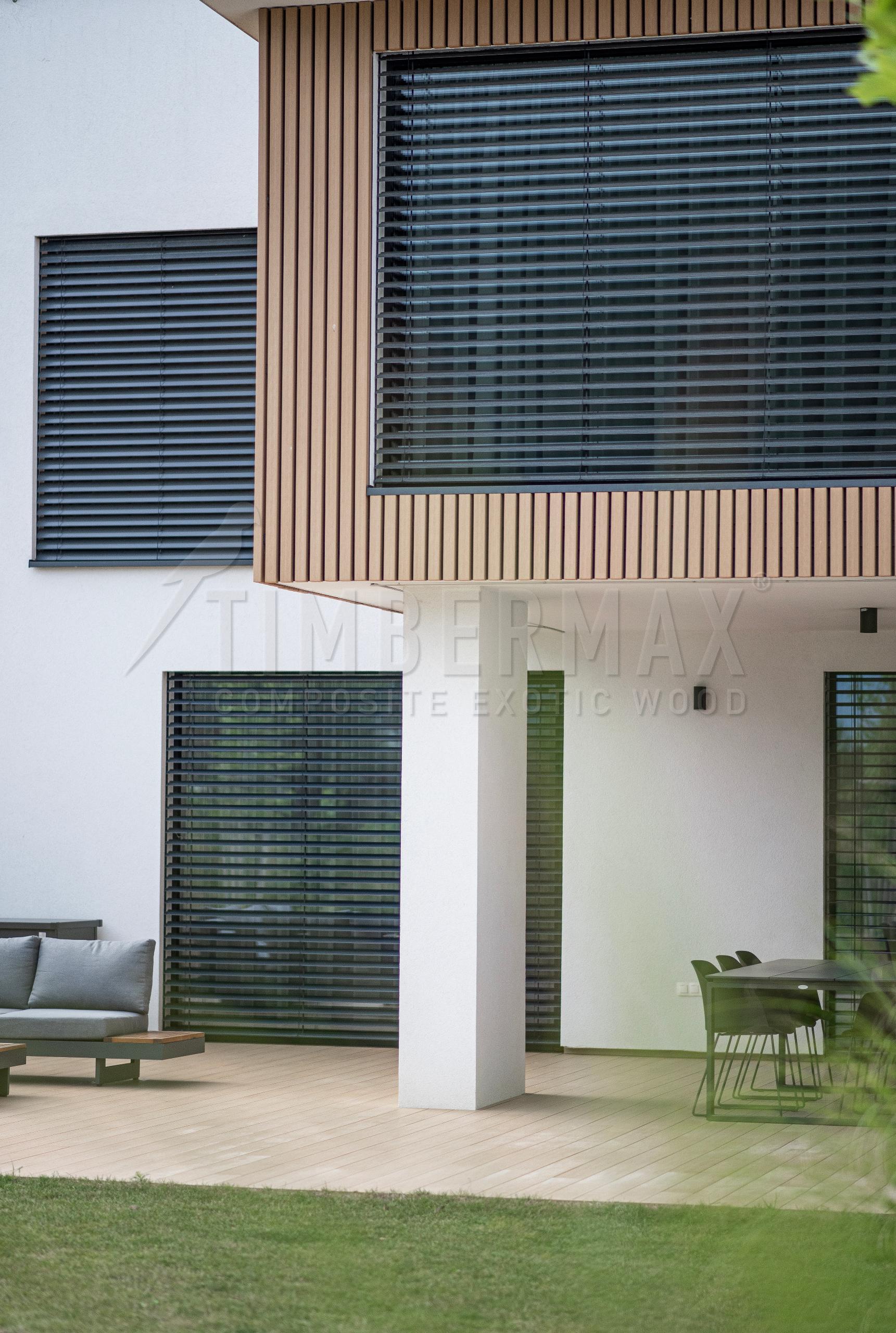 the facade of the house with vertical blinds and slatted facade cladding