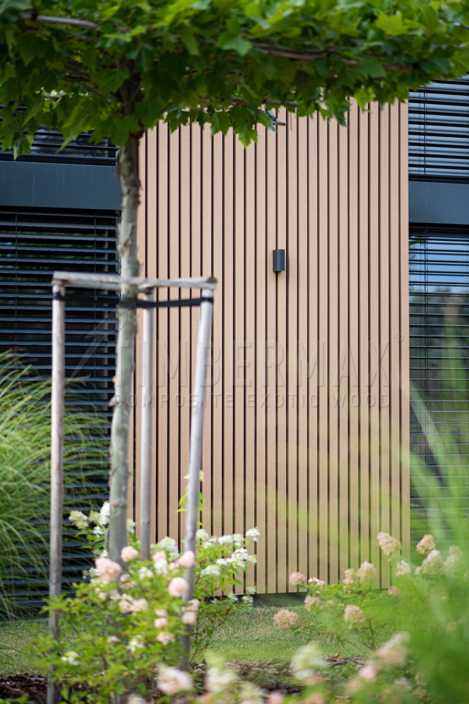 detail of the vertical sunshades made of composite boards on the facade of the house