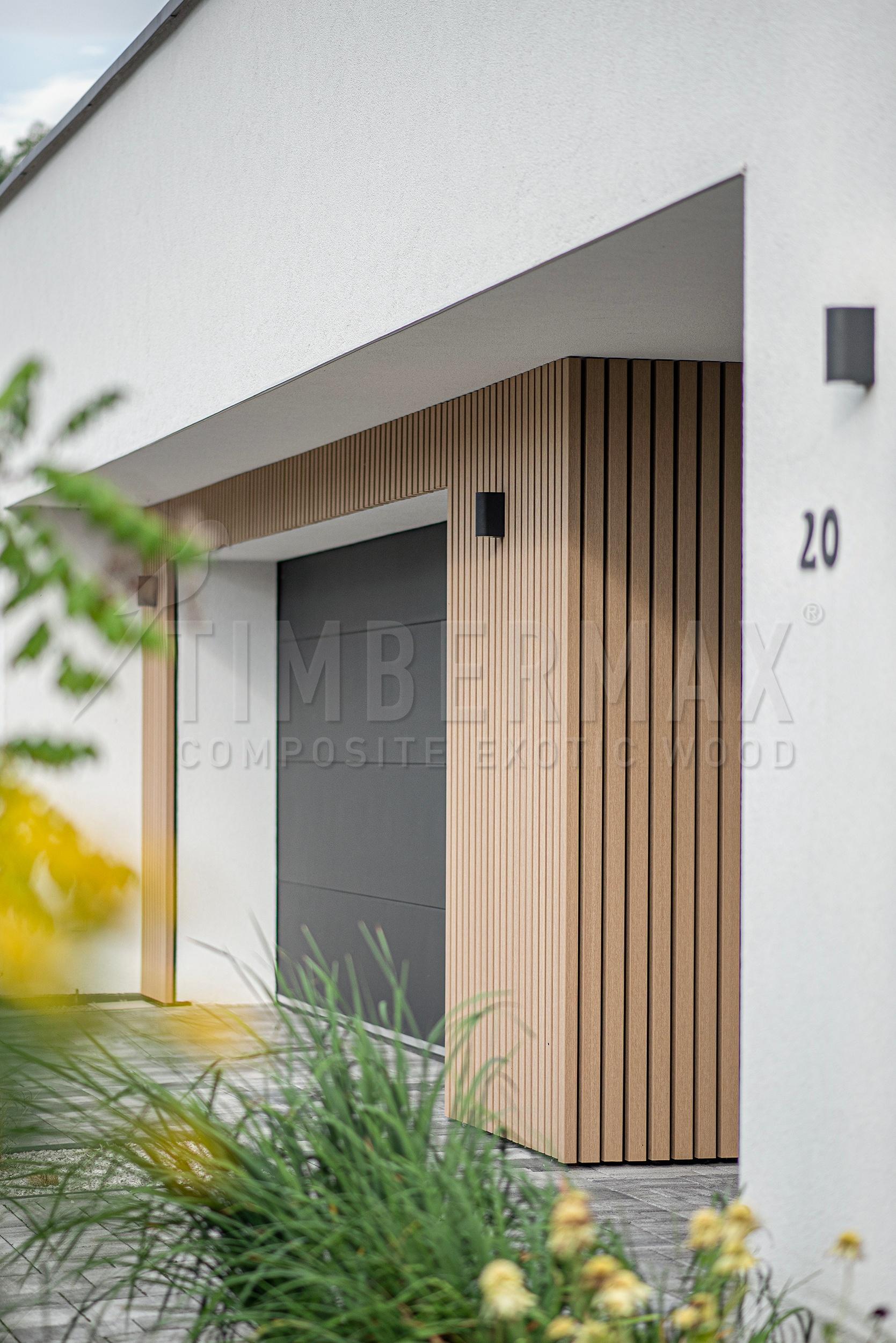 detail of the entrance to the house with wood-plastic sunshades on the facade