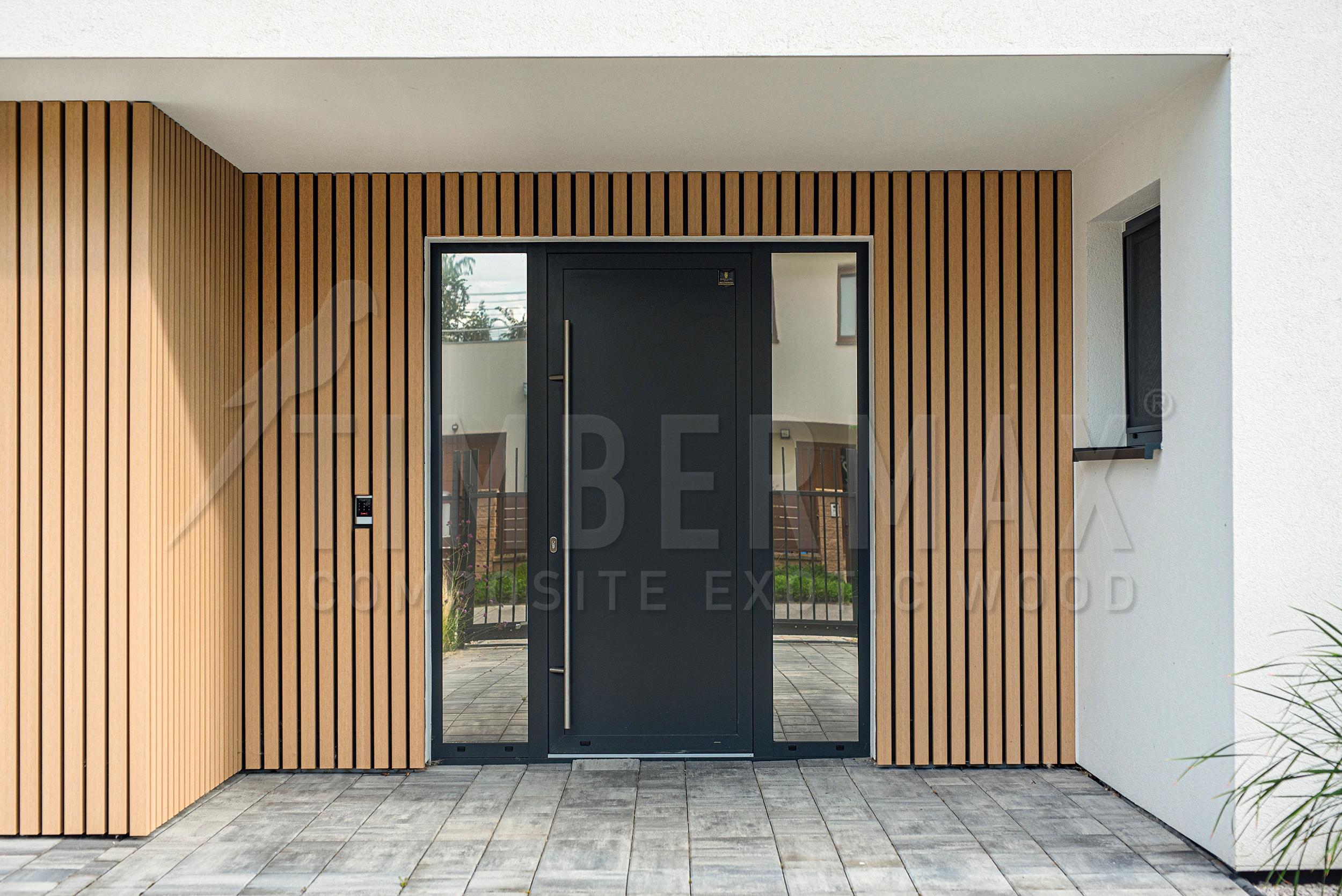 entrance to the house with vertical facade cladding and sunshades