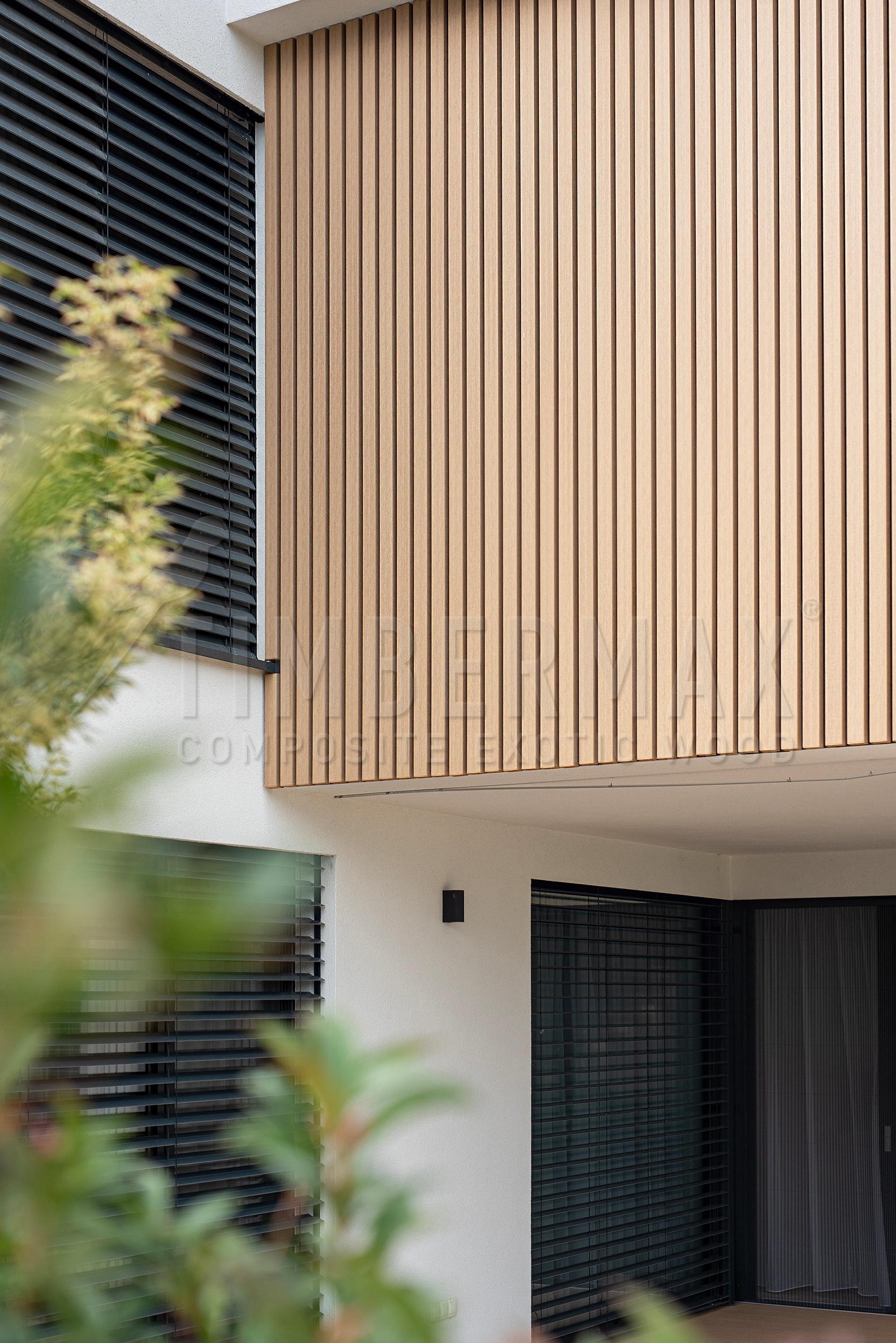 detail of lamella facade cladding imitating wood on a modern house