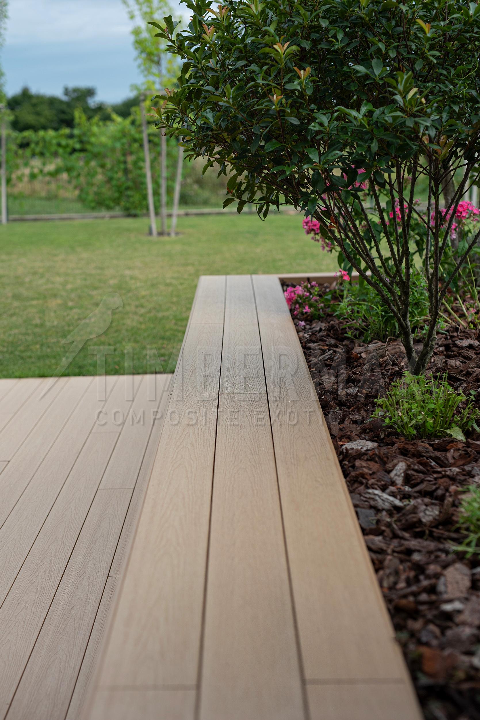 detail of the wpc floor for the terrace by the garden path