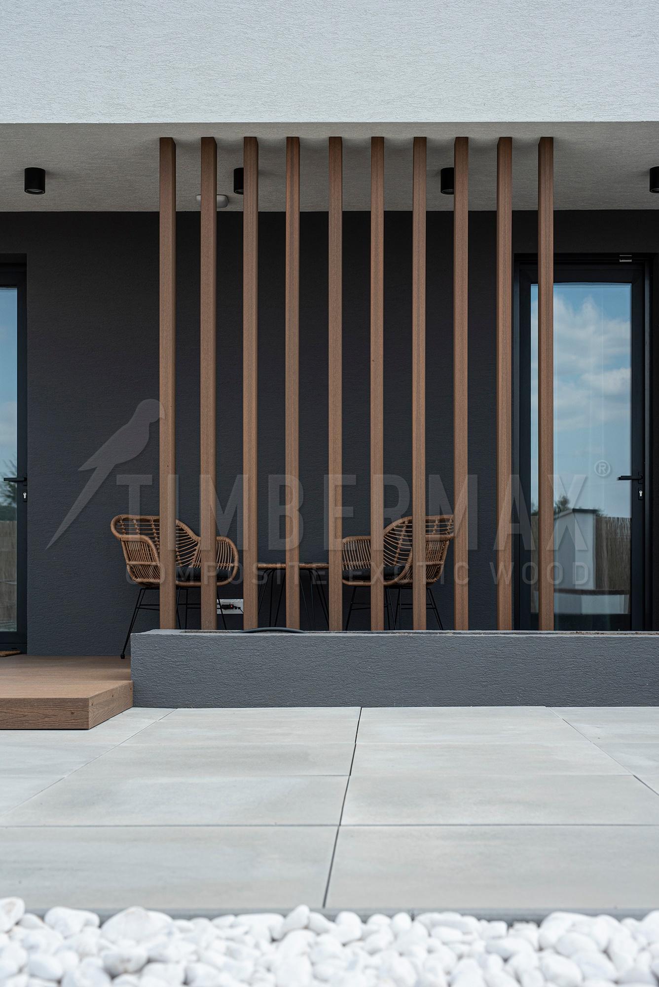 vertical sunshades made of composite boards on the facade of the house