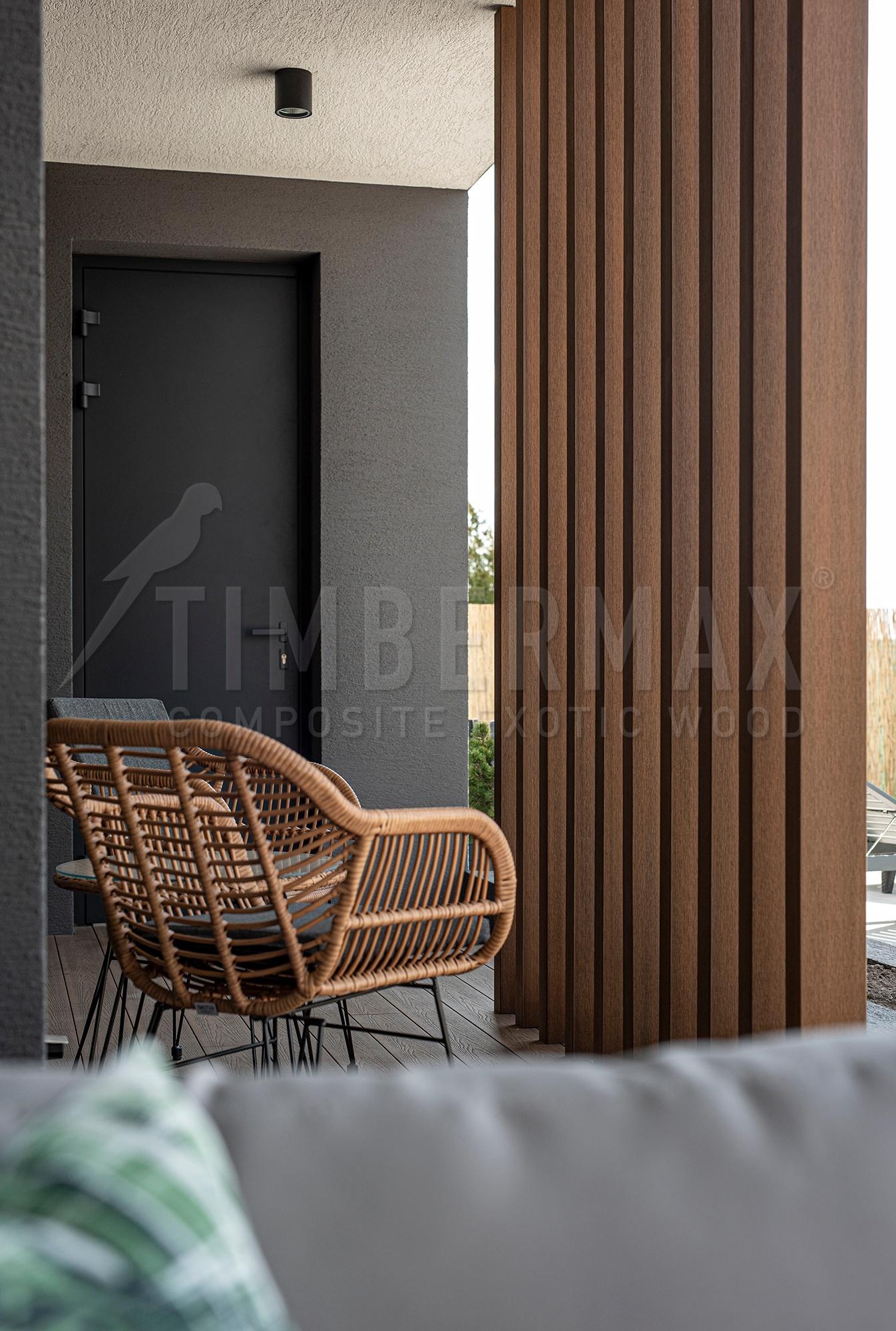 vertical sunshades made of composite boards on the facade of the house