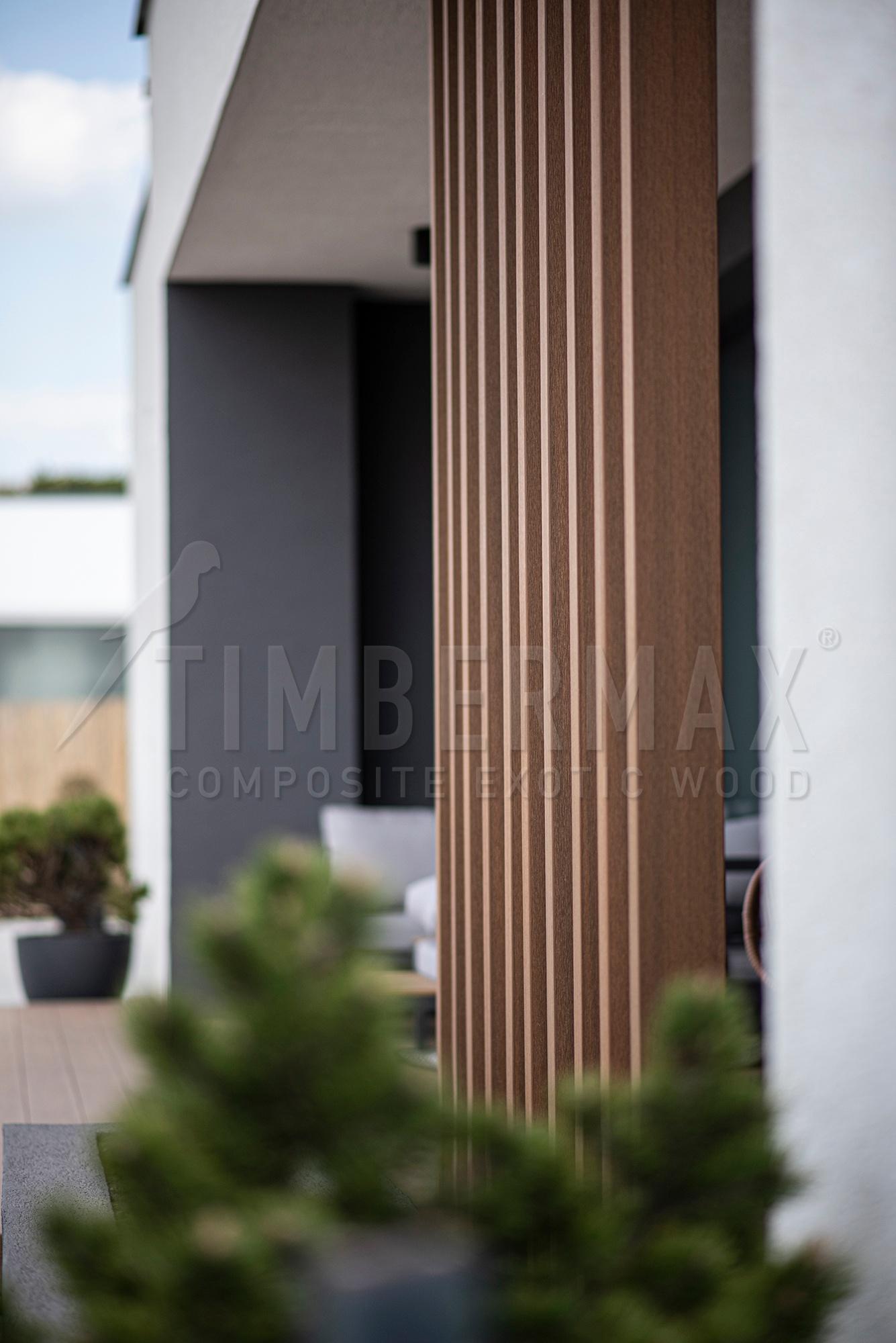 vertical sunscreens made of composite boards on the facade of a modern house