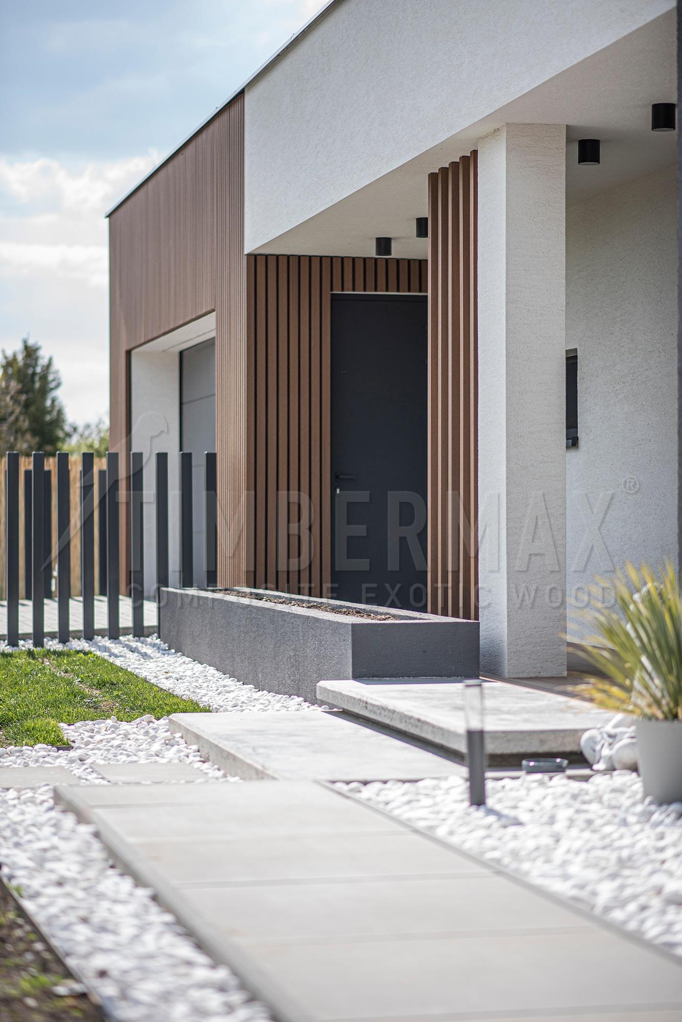 entrance to the house with a vertical slatted facade imitating wood